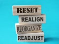 Reset realign readjust, word text written on wooden block, life business term Royalty Free Stock Photo