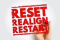 RESET REALIGN RESTART displayed in a bold stamp style held by a hand, symbolizing a fresh beginning, adjustment, and renewed Royalty Free Stock Photo
