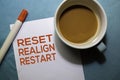 Reset Realign Restart text on the paper isolated on office desk background