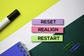 Reset. Realign. Restart text on sticky notes with office desk concept Royalty Free Stock Photo