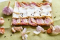 resh cold sliced bacon on the background of natural linen fabric. Fresh cooked food