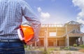 Resident engineer holding yellow safety helmet at new home building Royalty Free Stock Photo