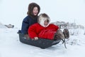 A resident of the tundra, indigenous residents of the Far North, tundra, open area, children ride on sledges, children in