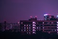 Residental buildings and condominium at night. Residential neighborhoods of the city in the night light. Apartments and purple sky