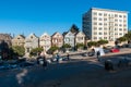 Residential architecture in San Francisco. Colorful building facades with a trees near it. Tourists walking on the streets and cro