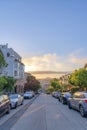 Residential area with roadside parking space and a view of sunset sky in San Francisco, CA