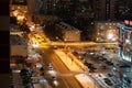 Residential areas on a winter night. Glowing windows of multi-storey residential buildings. A lot of parked cars in the yards