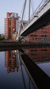 Residential block and footbridge with their reflection at Clarence Dock, Leeds Royalty Free Stock Photo