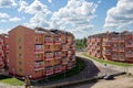 Residential brick houses with a sidewalk between them on a summer sunny day in the village of Taezhny, Krasnoyarsk Territory.