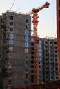 Residential building construction. Construction crane during the construction of a residential high-rise apartment building Royalty Free Stock Photo