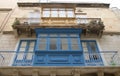 Residential building facade with colorful traditional wooden and iron balconies in Malta`s capital city Valletta Royalty Free Stock Photo