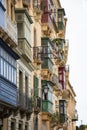 Residential building facades with colorful traditional wooden balconies in Malta`s capital city Valletta Royalty Free Stock Photo