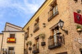 Residential building facades in Toledo, Spain with traditional balocnies with flower pots. Royalty Free Stock Photo