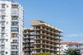 Residential building made of frame concrete under construction among residential multi-storey buildings Royalty Free Stock Photo