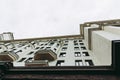 Residential building on the waterfront in Ar Deco style. Light beige color facade and spire on the roof. There are massive wooden Royalty Free Stock Photo