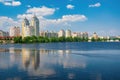 Residential buildings on the bank of Dnieper river reflected in the water at sunny summer day. Kyiv, Ukraine Royalty Free Stock Photo
