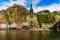 Residential buildings and Notre Dame de Dinant along Meuse River Royalty Free Stock Photo