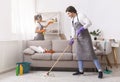 Residential Cleaning Services. Couple Of Skilled Housekeepers Tidying Up Apartment