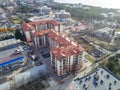 Residential complex of three multi-storey buildings with red roofs. The view from the top.