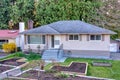 Residential family house with wooden garden beds on the front yard