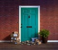 Residential front door with stacks of delivered boxes and newspapers; owner not home