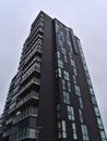 Residential high-rise building with expensive luxury apartments and black colored facade in downtown of Reykjavik in winter. Royalty Free Stock Photo
