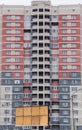 Residential high-rise multi-colored building made of red, gray and white bricks. Royalty Free Stock Photo