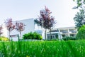 Residential home exterior simple Dutch preservationist style across lawn