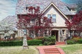 Residential home two story with colorful shingles and flowering trees in spring -rock with nice landscaping Royalty Free Stock Photo