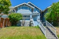 Residential house with concrete stairway over terrace to the entrance.