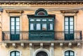 Residential house facade with traditional Maltese wooden balcony