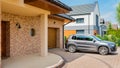 Residential house with silver suv car parked on driveway in front Royalty Free Stock Photo