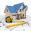 Residential house with tools on architect blueprints. Royalty Free Stock Photo