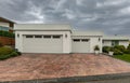 Residential house two car garage. Modern and luxurious double garage with driveway and roller door Royalty Free Stock Photo