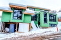 Residential house under construction with snowy roof on a winter landscape Royalty Free Stock Photo