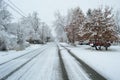 Residential neighborhood city street in severe snowstorm long street view Royalty Free Stock Photo