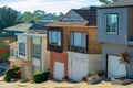 Residential neighborhood in late afternoon shade with visible windows and garage doors with clear blue sky background Royalty Free Stock Photo