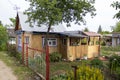 Residential old wooden house behind an iron high fence