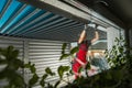 Residential Pergola Installer Performing Final Check on a Newly Built Carport Pergola Royalty Free Stock Photo