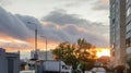 Residential quarter with buildings, cars on the background of a gentle sunset in the evening, outdoor in summer