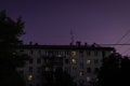 Residential Russian apartment building on a background of purple sunset