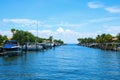 Residential saltwater canal in south Florida with blue water and many boats docks and palm trees Royalty Free Stock Photo