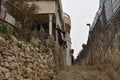 residential stone building in Jerusalem with black clothes on a clothesline, old town street stone steps Israel 2021
