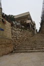 residential stone building in Jerusalem, Israel with black clothes on a clothesline, old town street with stone steps