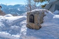 Residential stone mailbox surrounded by snow in Park City Utah viewed in winter