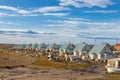 Residential wooden houses on a dirt road next to the airport in Pond Inlet, Baffin Island, Canada.