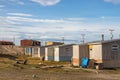 Residential wooden houses on a dirt road in Pond Inlet, Baffin Island, Canada.