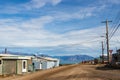 Residential wooden houses on a dirt road in Pond Inlet, Baffin Island, Canada.