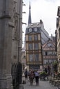 Residents of the city and tourists walk in the historic center and relax in a cafe on a street of Rouen, France