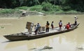 Residents crossing the river by boat solo canoe as a means of crossing to and from Solo Centra Java Indonesia. Royalty Free Stock Photo